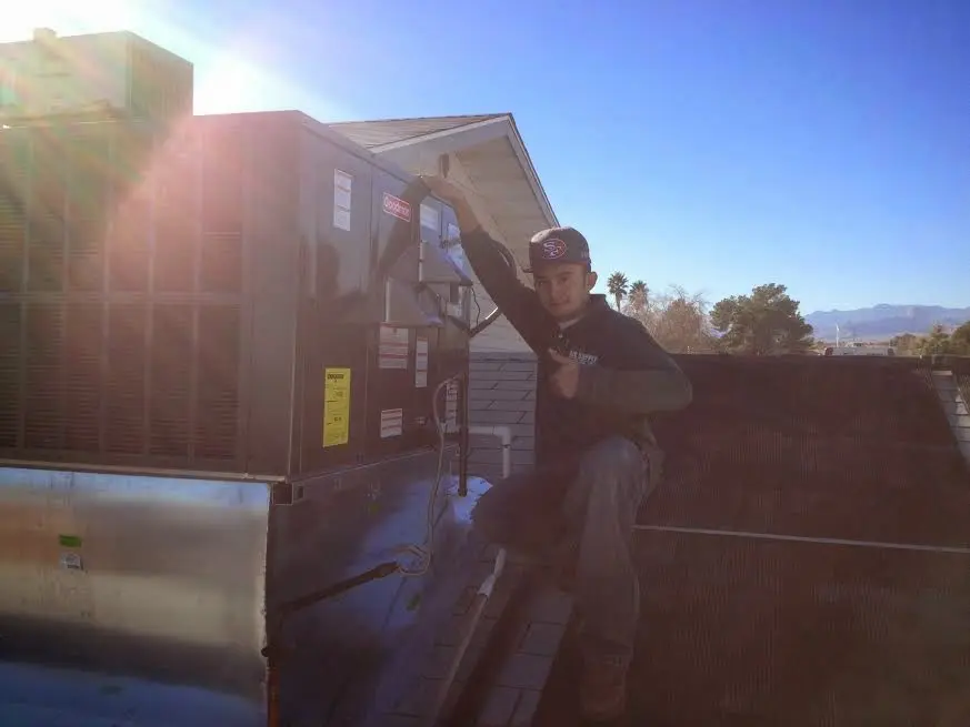 HVAC technician performing HVAC Inspection on a rooftop unit in Grand Island